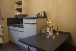 a small kitchen with a table with glasses on it at Apartment Henriette in Oranienbaum-Wörlitz