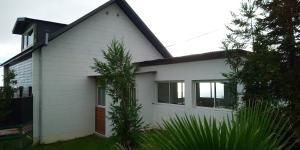 a white house with a black roof at Le Tranquillou in La Plaine des Cafres