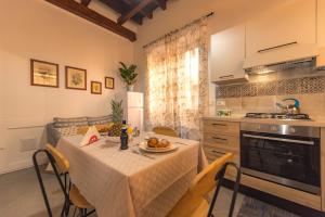 a kitchen with a table with a plate of food on it at AMUNI' Apartments in Trabia