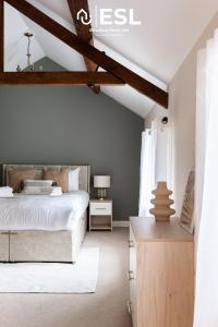 a bedroom with a white bed and a wooden ceiling at Super Central - Quiet - 2 Bedroom Cottage in Shrewsbury