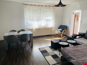 a small living room with a table and a couch at Apartment Zvečaj in Đakovo