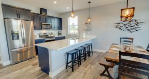 a kitchen with a large island with bar stools at Deja Blue in Ocean Shores
