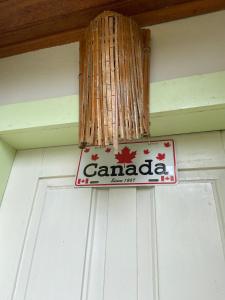 a canadian sign hanging on a front door at Chalés Lavras de Minas - Canadá in Lavras Novas