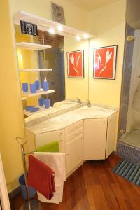 a bathroom with a large sink and a shower at Merville House in Florence