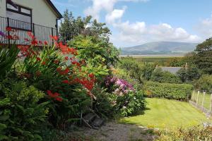 a garden with colorful flowers and a house at Halsteads: peaceful location, stunning views in Soutergate