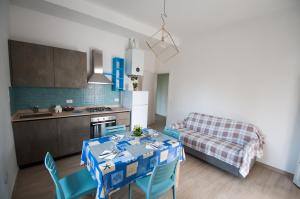 a kitchen with a table and chairs in a room at vada vacanze in Vada