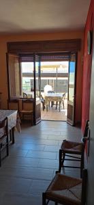 a living room with a view of a patio at Lungomare Bed rooms in Santa Maria Navarrese