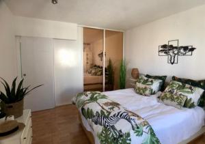 a bedroom with a large white bed with pillows at La casa de Leones in Peniscola