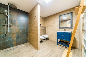 a bathroom with a blue sink and a shower at Krasne Domki in Krasnobród