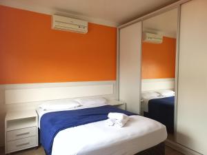 um quarto com 2 camas e um espelho em Residencial Nicole em Florianópolis