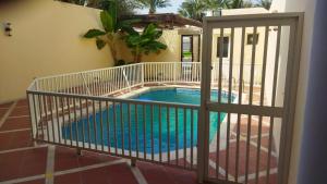 a swimming pool behind a fence with a gate at درة العروس كورال بيتش فيلا in Durat Alarous