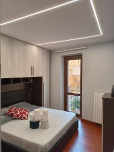a bedroom with a bed and a large window at La casa in piazzetta in Enna