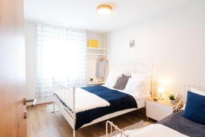Posteľ alebo postele v izbe v ubytovaní OAK Residents Siófok