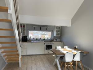 a kitchen and dining room with a table and chairs at Apartament Górska Fantazja in Ustroń