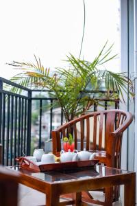 a wooden table with a bowl of fruit on a table at City Heaven Ella in Ella