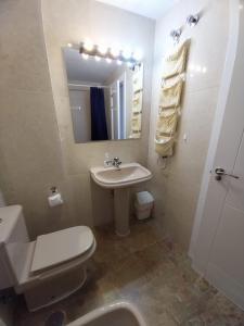 a bathroom with a sink and a toilet and a mirror at Albir Azul in Albir