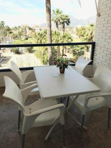 a white table and chairs on a balcony at Albir Azul in Albir