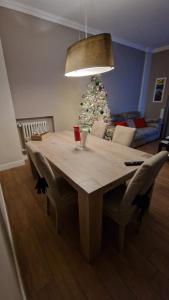a dining room table with chairs and a christmas tree at Casa GIOIA Luxury in Taranto