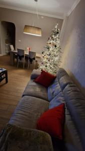 a living room with a couch and a christmas tree at Casa GIOIA Luxury in Taranto