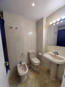 a bathroom with a toilet and a sink at Albir Azul in Albir