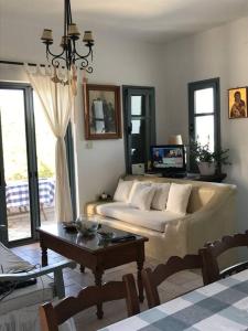 a living room with a couch and a table at Semini Villa in Kalymnos