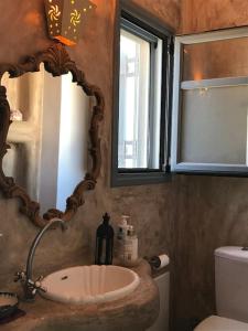 a bathroom with a sink and a mirror at Semini Villa in Kalymnos