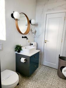 a bathroom with a sink and a toilet and a mirror at Queen Room - House of Chess in Satu Mare