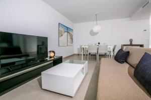 a living room with a couch and a table at Prime Spanish Holidays - Arenal Dream in Jávea