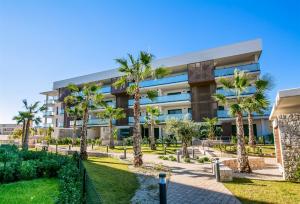 a building with palm trees in front of it at Prime Spanish Holidays - Arenal Dream in Jávea