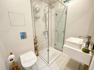 a bathroom with a shower and a toilet and a sink at New luxury furnished apartment - beach, Varna center & fast Wi-FI in Varna City
