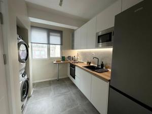 a kitchen with a sink and a washing machine at New luxury furnished apartment - beach, Varna center & fast Wi-FI in Varna City