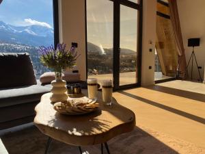 una mesa en la sala de estar con vistas a la montaña en Cabana Ana en Borşa