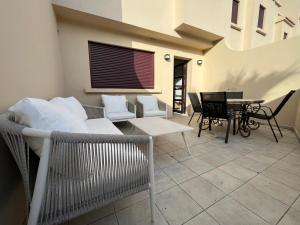 a patio with a couch and chairs and a table at Chalet Adosado El Medano in El Médano