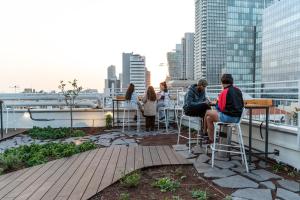 a group of people sitting on the roof of a building at Abraham Tel Aviv in Tel Aviv