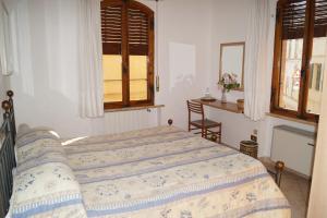 a bedroom with a bed and a table and a window at Il Pozzo Della Citerna in Castelnuovo Berardenga