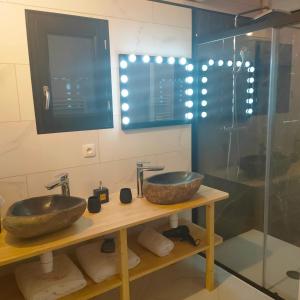 a bathroom with two sinks and a glass shower at Le château des fées in Illoud +35 photos
