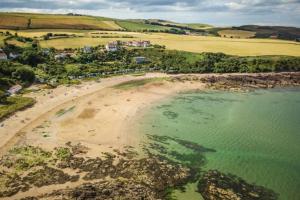 an aerial view of a beach and the ocean at Romantic luxury Cottage right next to the ocean in Saint Abbs