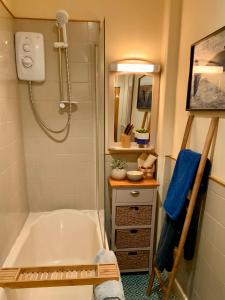 a bathroom with a bath tub and a shower at Romantic luxury Cottage right next to the ocean in Saint Abbs