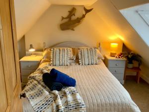 a bedroom with a bed in a attic at Romantic luxury Cottage right next to the ocean in Saint Abbs