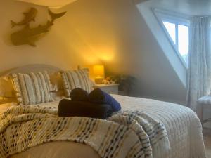 a bedroom with a bed with a teddy bear on it at Romantic luxury Cottage right next to the ocean in Saint Abbs