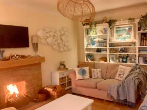 a living room with a couch and a fireplace at Romantic luxury Cottage right next to the ocean in Saint Abbs