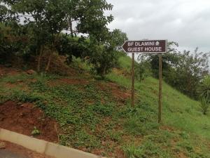 a sign for a guest house on a hill at BF Dlamini Guesthouse in Amanzimtoti