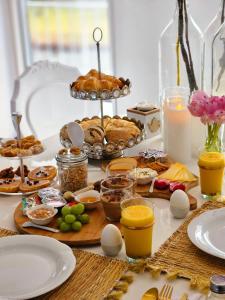 a table with breakfast foods and drinks on it at B&B Apartment Amsterdam Schiphol Airport in Hoofddorp