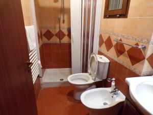 a bathroom with a toilet and a sink at IL PORTICCIOLO Apartment - Via Umberto 25 in Giardini Naxos