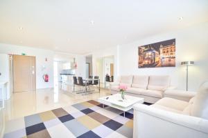 a living room with white furniture and a checkered floor at WIOLA SeaView Apartment by MOJE Holiday in Lagos