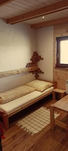 ein Zimmer mit einem Bett in der Ecke eines Zimmers in der Unterkunft DREVENÁ CHALÚPKA Slovenský raj HRABUŠICE in Hrabušice