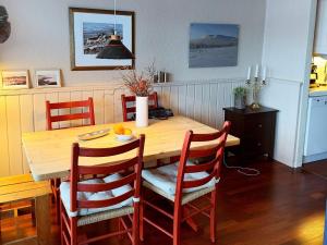 a kitchen with a wooden table with four chairs at Apartment HOVDEN II in Hovden