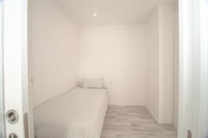 a white room with a bed in the corner at Paraiso Suites with Mega Views, Sea and Mountain. in Playa Paraiso