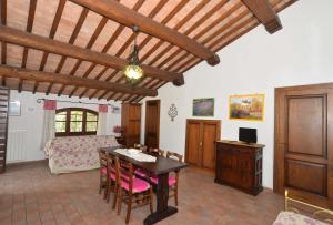 a living room with a table and a bedroom at Agriturismo Sant'Angelo in Acquapendente