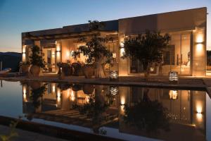 a house with a pool in front of it at night at Villa Shangri-La in Katomérion